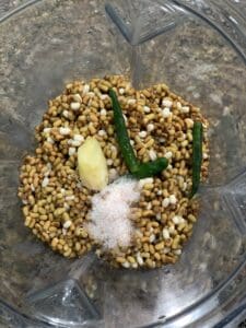 Soaked beans in a blender with green chilli, ginger, salt and cumin seeds.
