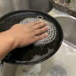 Scrubbing with a chain mail scrubber.