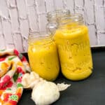 Ginger garlic paste in mason jars with garlic in picture.