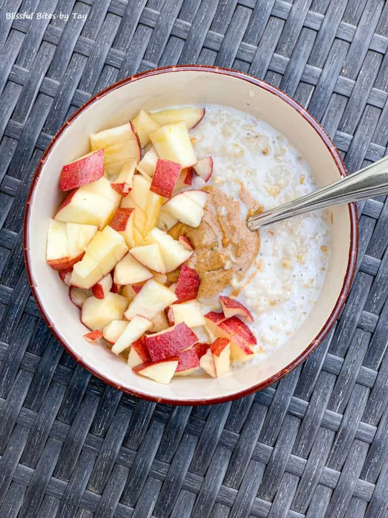 Steel cut oatmeal with nut butter and apple pieces.