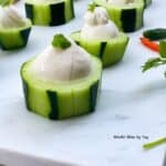 Cucumber cup with Yogurt dip and cilantro on top.