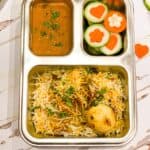 Egg Biryani with mirchi ka salan and carrot and cucumber veggies shapes.