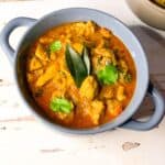 Andhra style Chicken curry with curry leaves on top.