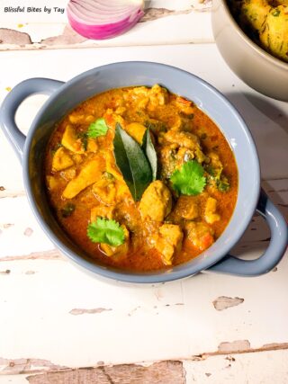 Andhra style Chicken curry with curry leaves on top.