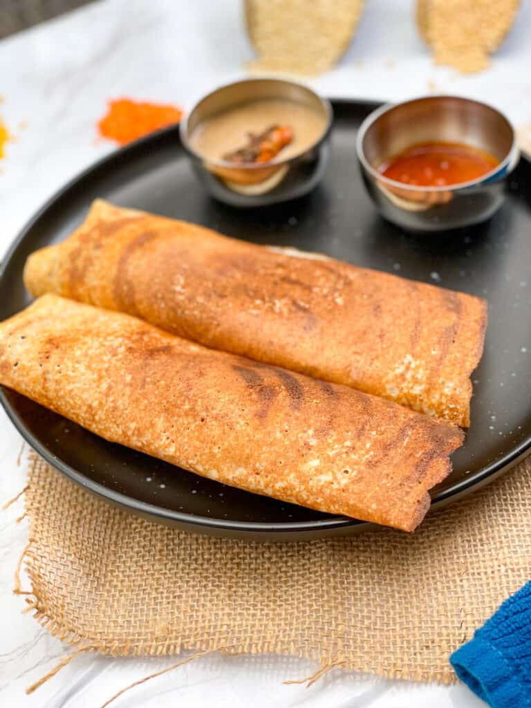 Two quinoa dosa with peanut chutney and ginger chutney.