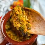 Brussels sprouts curry in a wooden spoon in close shot.