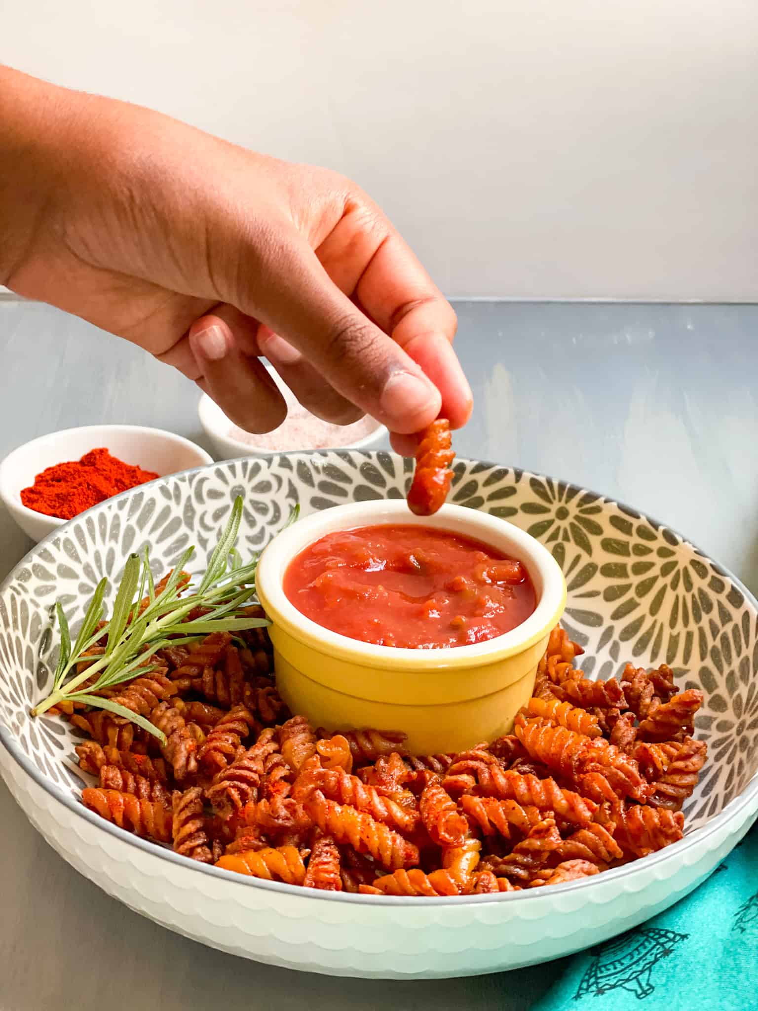 Dipping the pasta chip in salsa.